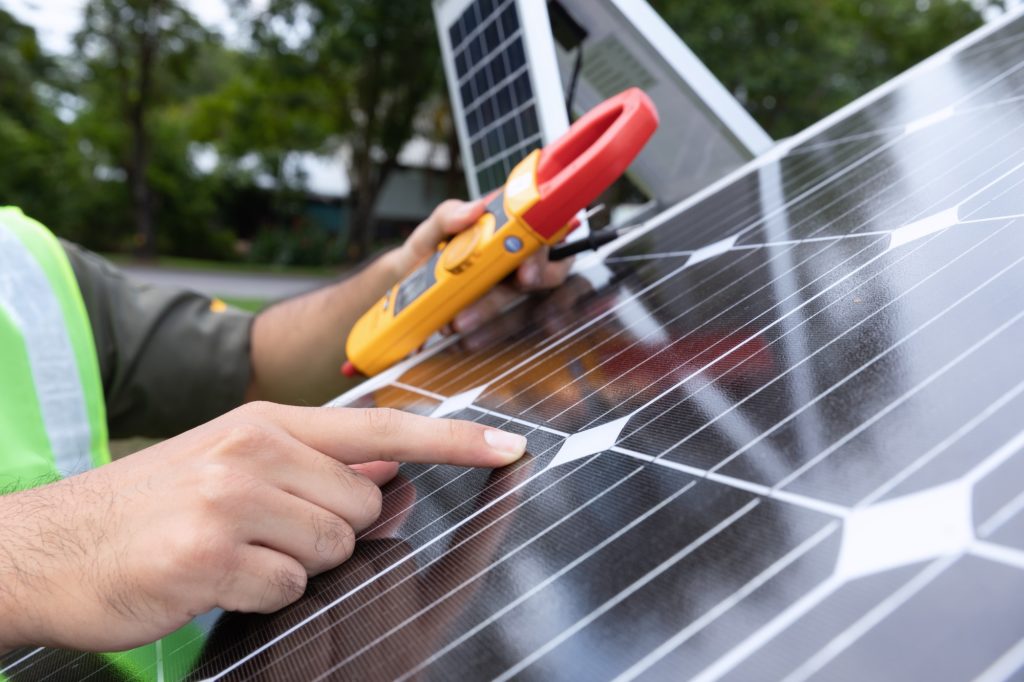 Edinburgh Gas Renewables Engineer with energy measurement tool photovoltaic modules for renewable energy